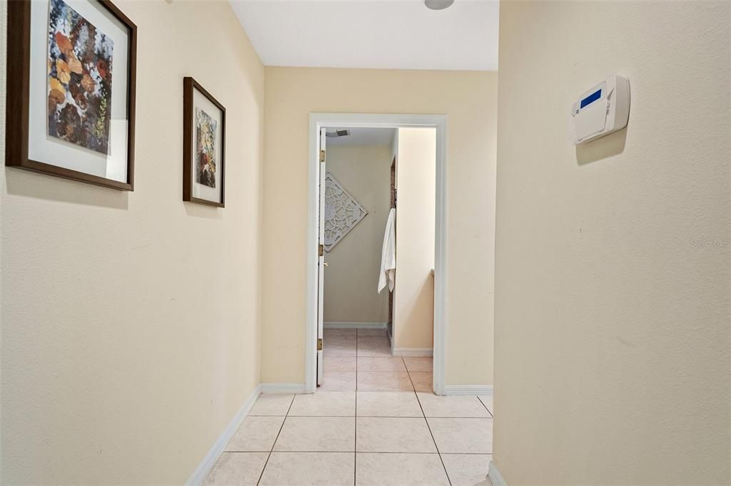 The hallway links the kitchen to the laundry room and lower level guest bedroom.