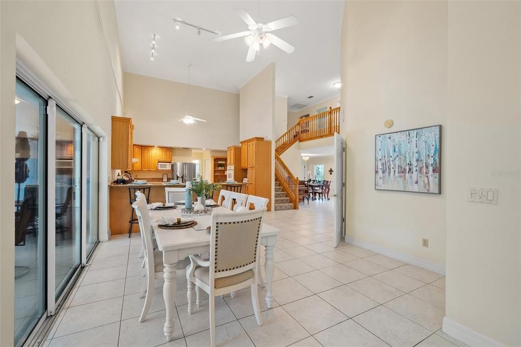 The kitchen area is designed with an open concept, allowing for a seamless view of the pool area through large sliding glass doors.