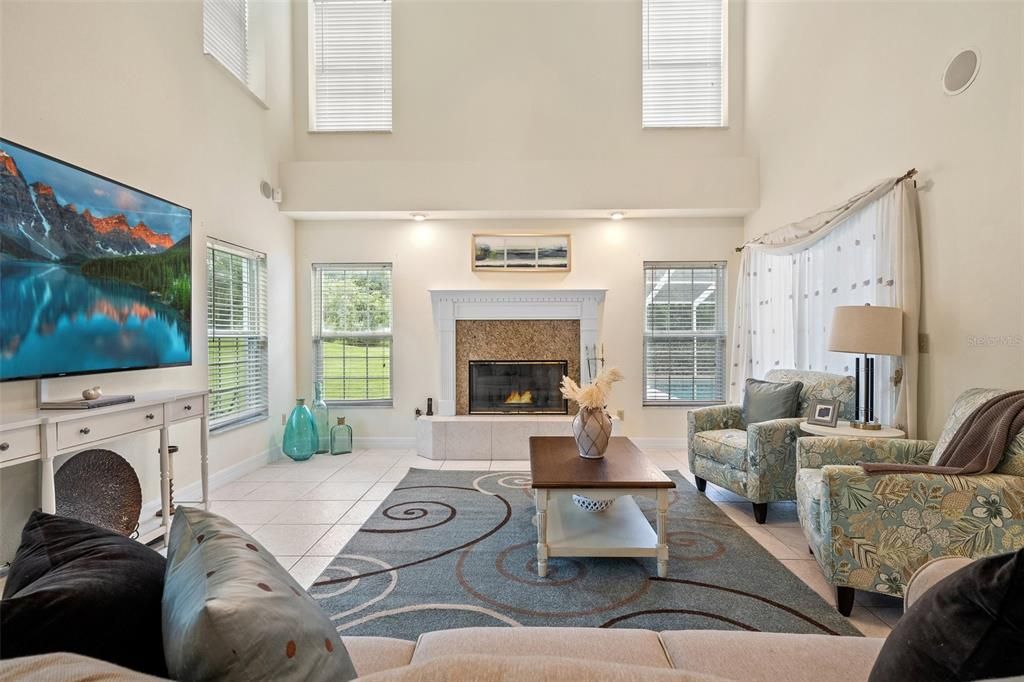 The family room is adorned with abundant natural light, thanks to its large windows and soaring ceilings. It boasts a generous space, providing ample room for everyone to relax and unwind. The centerpiece of the room is a charming fireplace, adding a warm and cozy ambiance to the entire space.