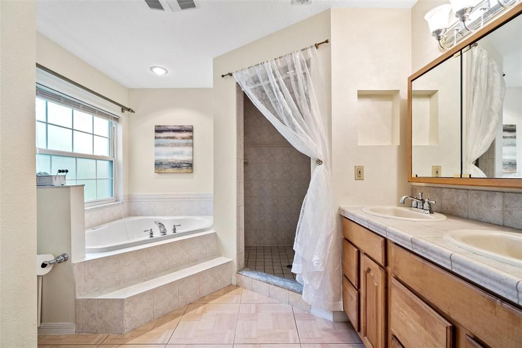 This room serves as a lower-level owner's suite, complete with a spacious sitting room, an expansive bedroom, and a luxurious full bathroom for exclusive use.