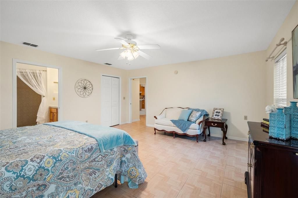 This room serves as a lower-level owner's suite, complete with a spacious sitting room, an expansive bedroom, and a luxurious full bathroom for exclusive use.