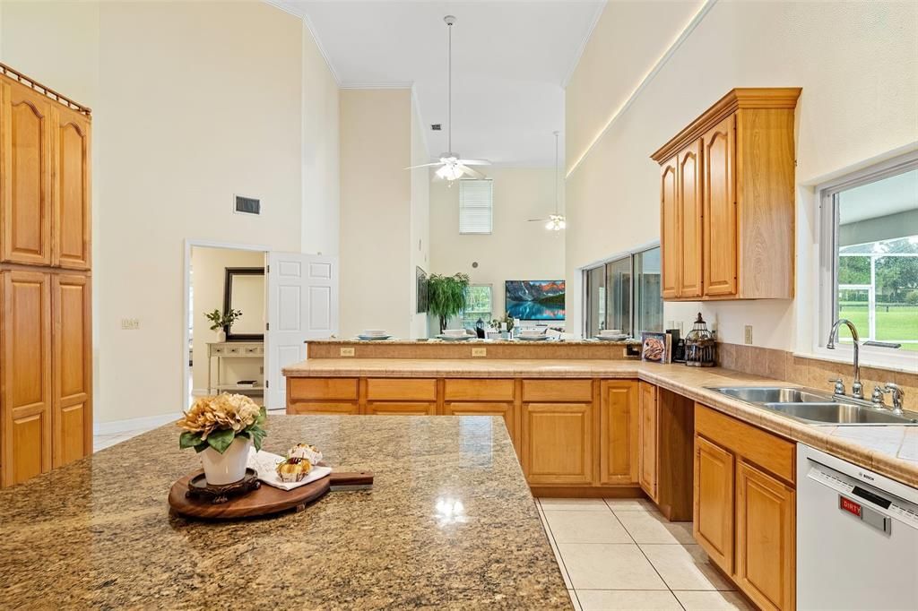 The kitchen area is designed with an open concept, allowing for a seamless view of the pool area through large sliding glass doors.
