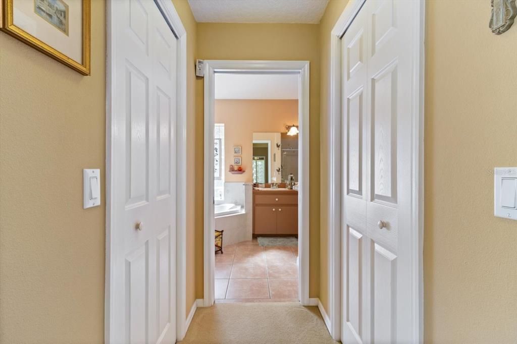 Master hallway with two closets leading to master bath
