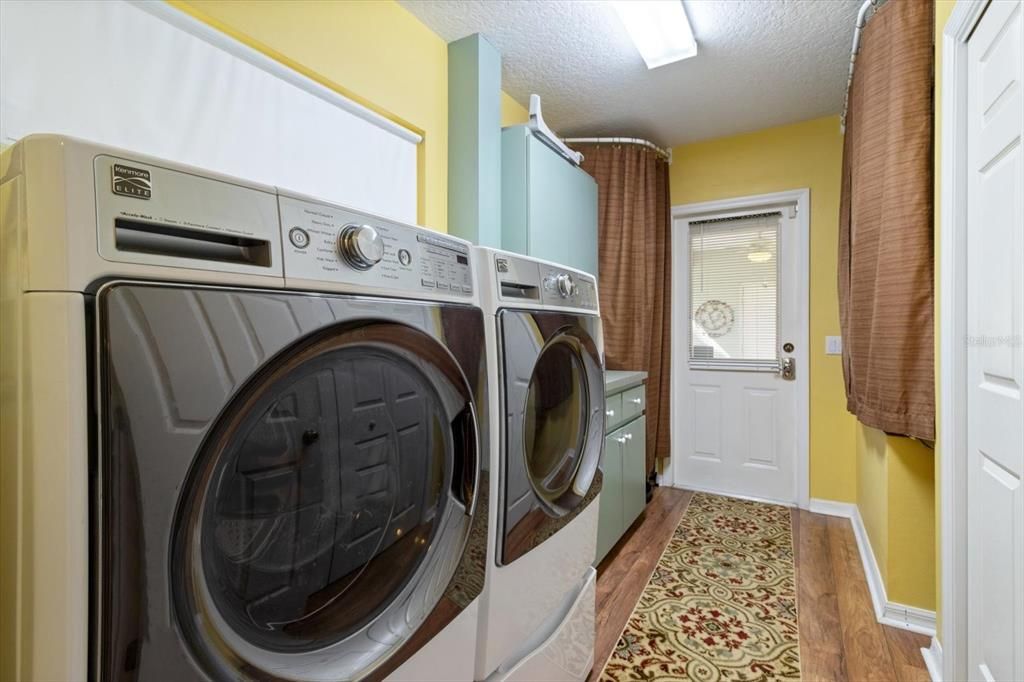 Laundry room with large pantry adjacent to kitchen