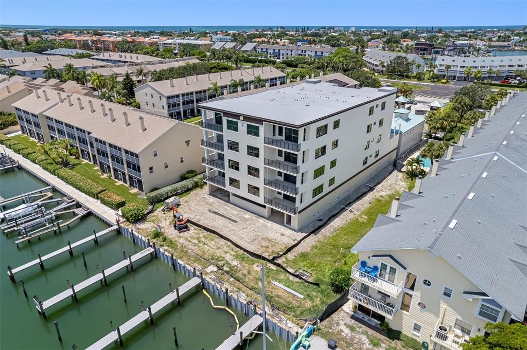 The boat slips are 50' long.  12' width without a boat lift. 10.4' with a boat lift. Electricity can accommodate up to a 35,000 lb boat lift.  The land between the boat dock and building will be a tropical pool and lanai oasis.