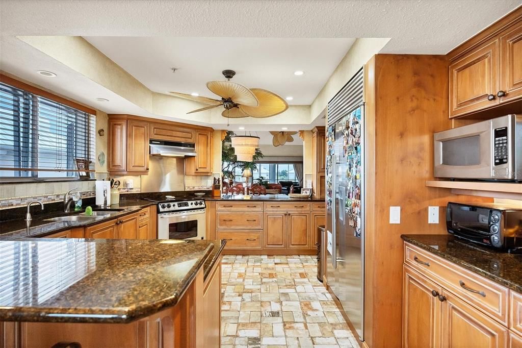 Spacious Kitchen features Stainless appliances, granite & Mediterranean tile floors
