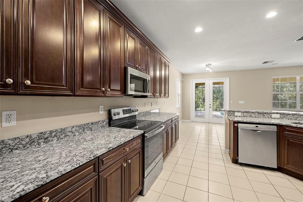 KITCHEN and BREAKFAST-NOOK with Breakfast-Bar and French-Doors to Pool and Extended Lanai