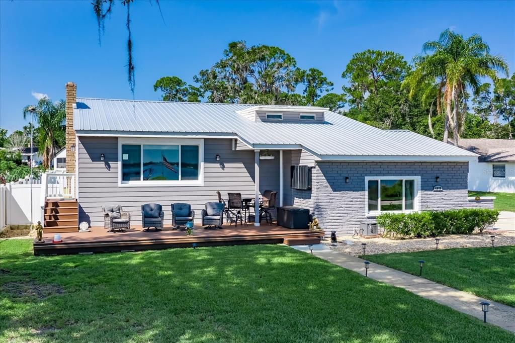 Beautiful lake front home on stunning Lake Jackson, with a white sandy beach, (3) additional sheds on the property on almost a full acre of land.  NOTE: Front door is just up the steps to the left.