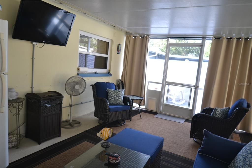 Lanai with another TV and door to the pool