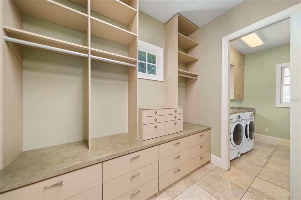 Walk-in Closet Primary bedroom with entrance to laundry room