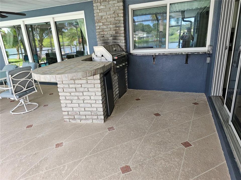 grill with refrigerator on pool deck area