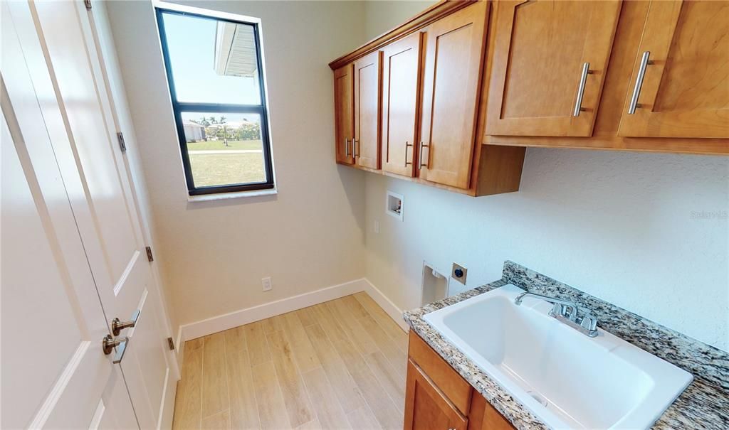 Laundry room off kitchen and large pantry