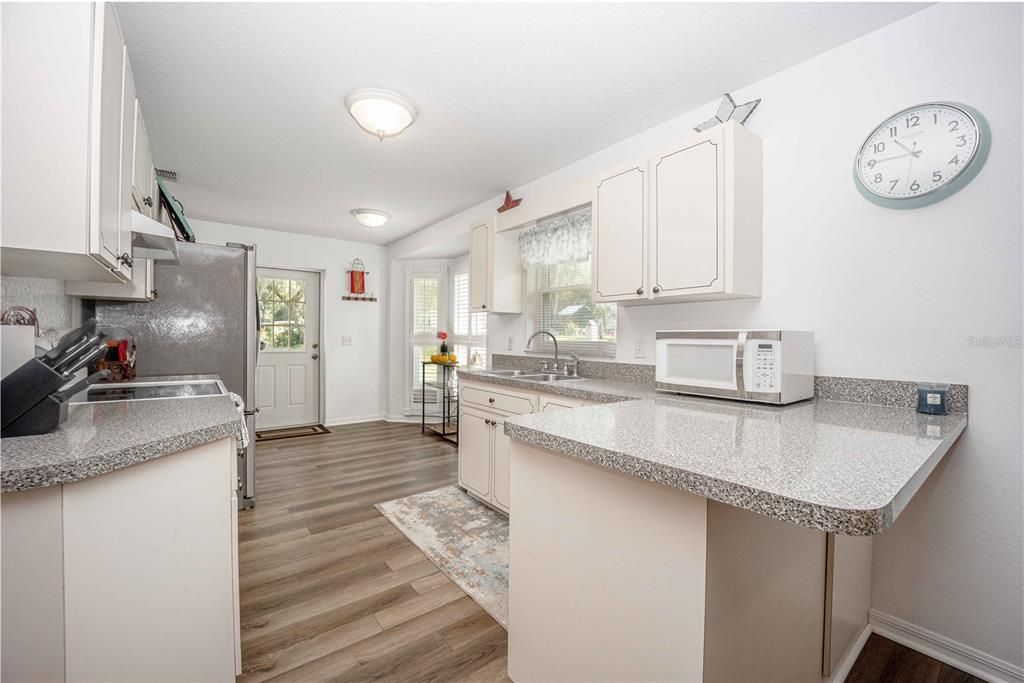 Spacious kitchen with ample counter space and access to the back yard