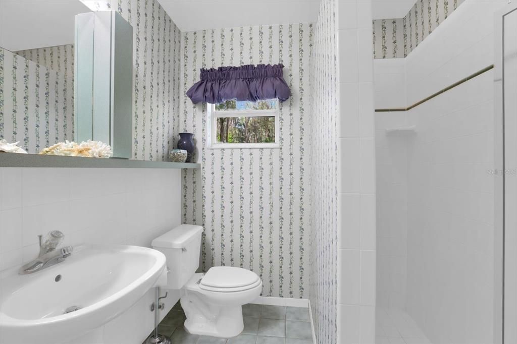 This bathroom is between two of the bedrooms. It is the second bath in this home & has a shower.