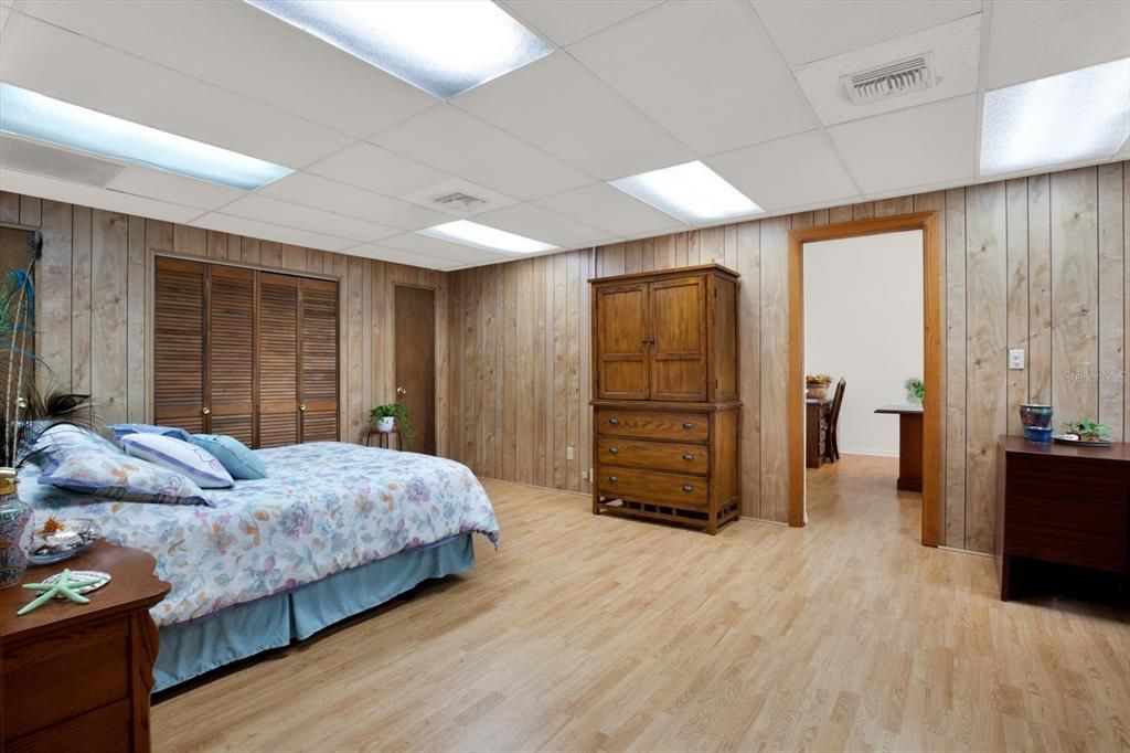 This bedroom has an adjoining office space or bonus room. A door separates the two rooms for privacy.