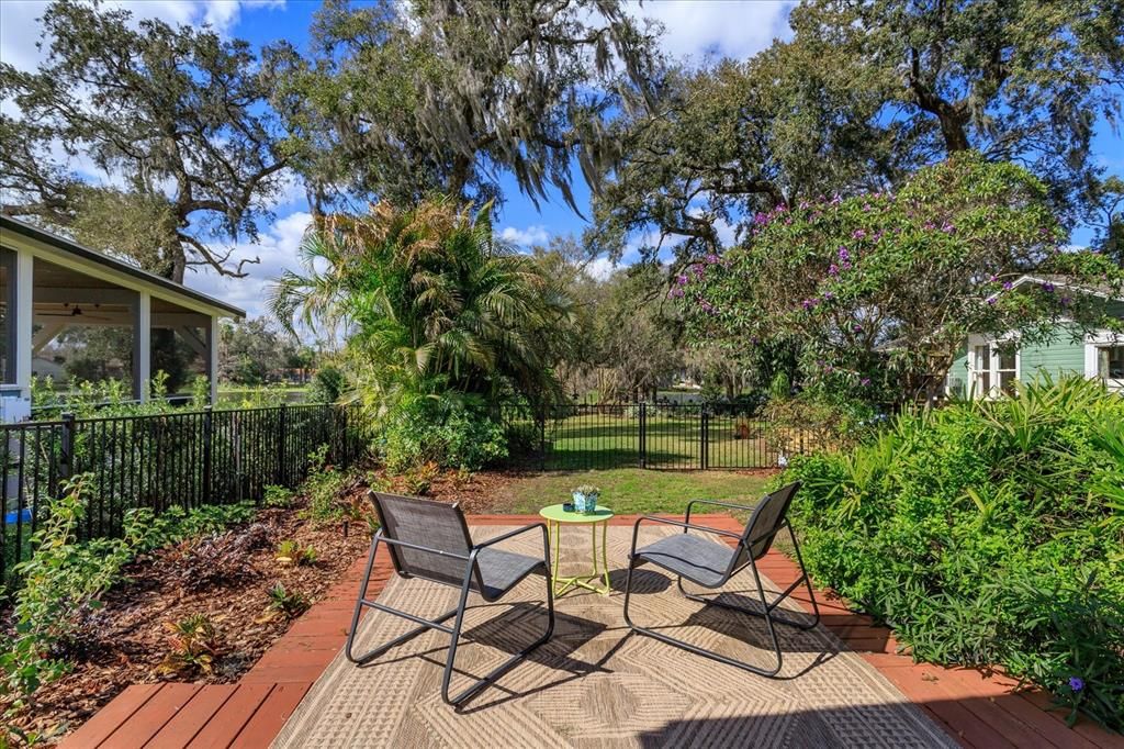 Patio with view of beautifully landscaped yard and lake