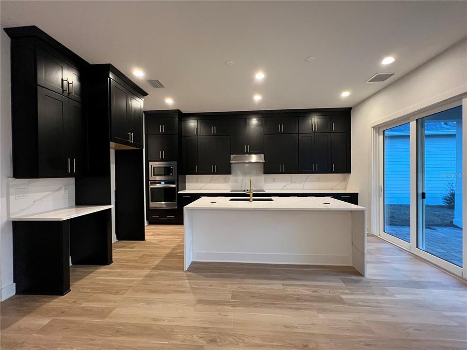 Gourmet Kitchen with waterfall island and double-stacked cabinetry