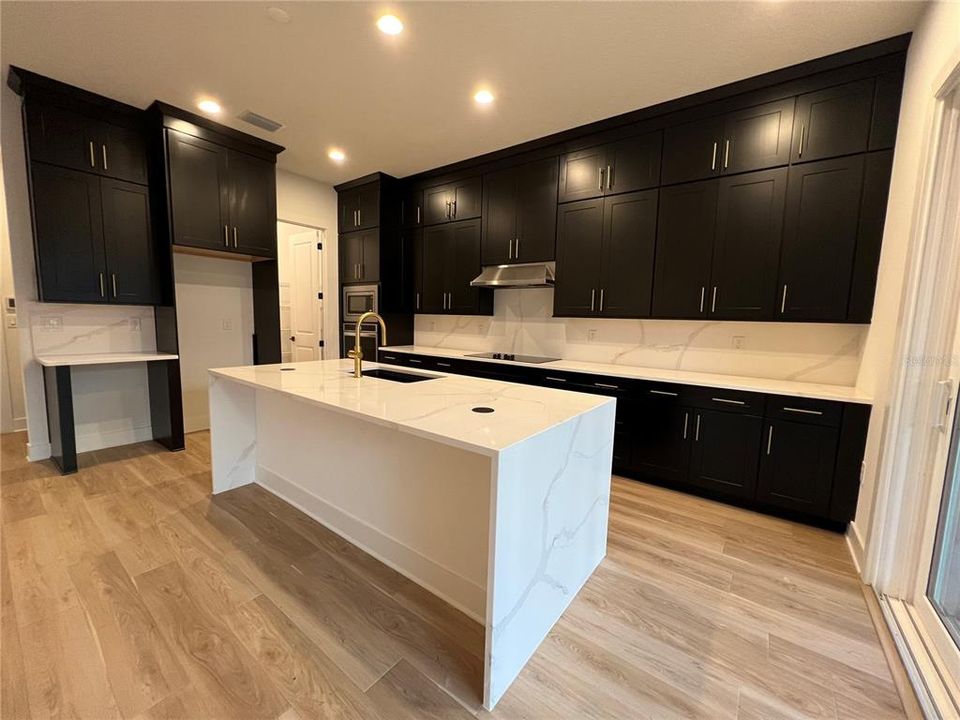 Gourmet Kitchen with waterfall island and double-stacked cabinetry