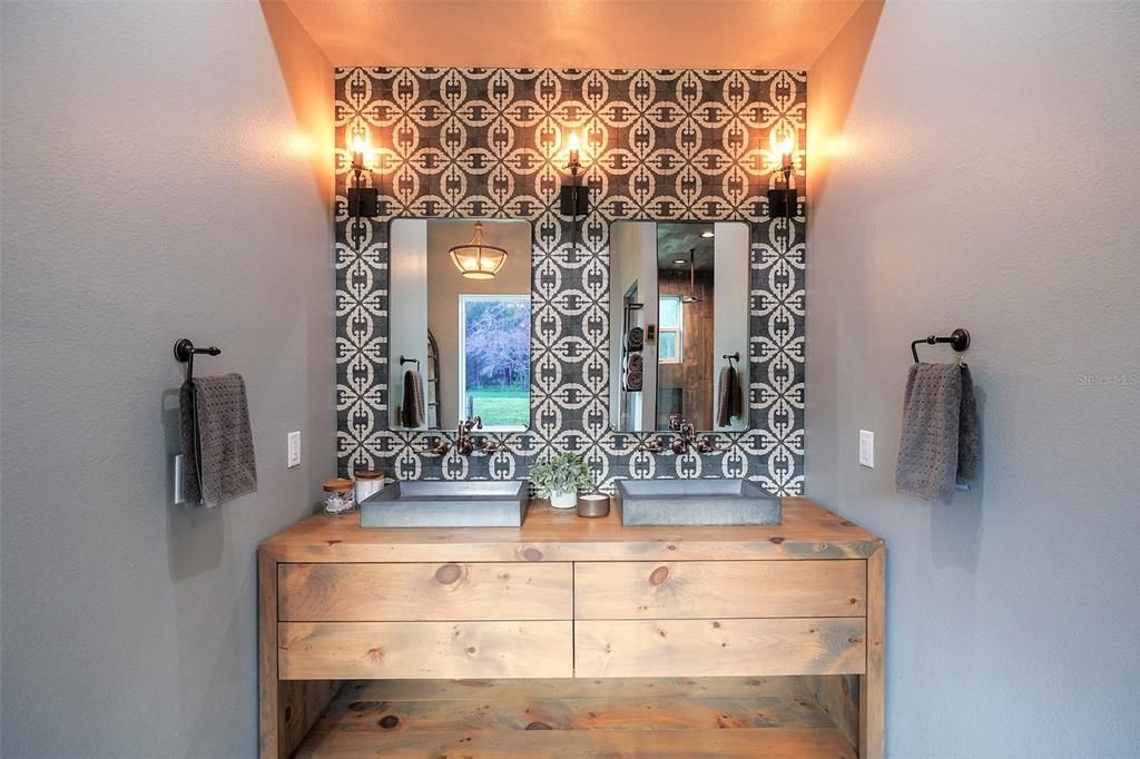 custom solid wood vanity w/ double concrete sinks & signature hardware oil brushed faucets, deco tile floor to ceiling backsplash