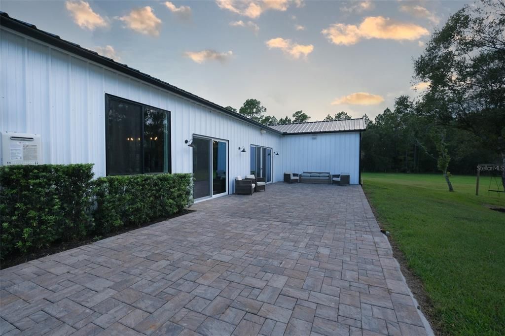 18x55 brick paver Lani. Pavers connect house to detached garage.