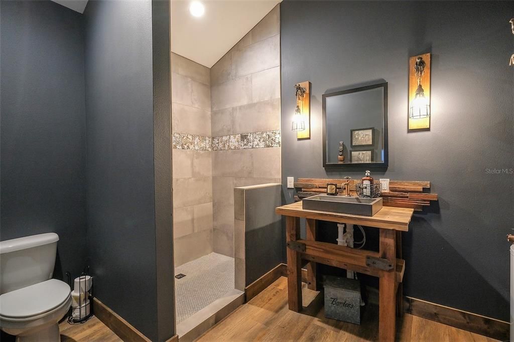 3rd full bathroom in 2nd level detach w/ concrete sink & custom vanity.