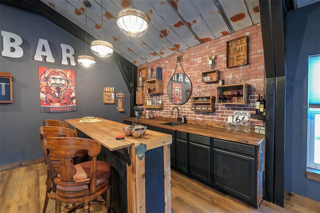 mini fridge & sink in back bar. Bar stools stay.