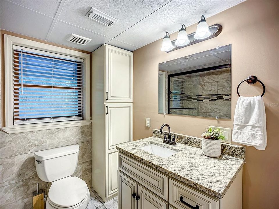 Full bathroom completely renovated in 2022 complete with beautiful soft close cabinetry.