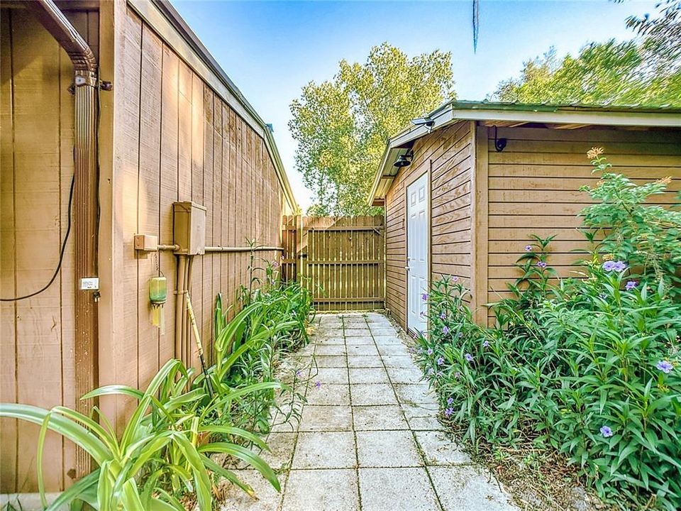 Paved walkway behind 2 car garage to the pump house that houses your RO system.