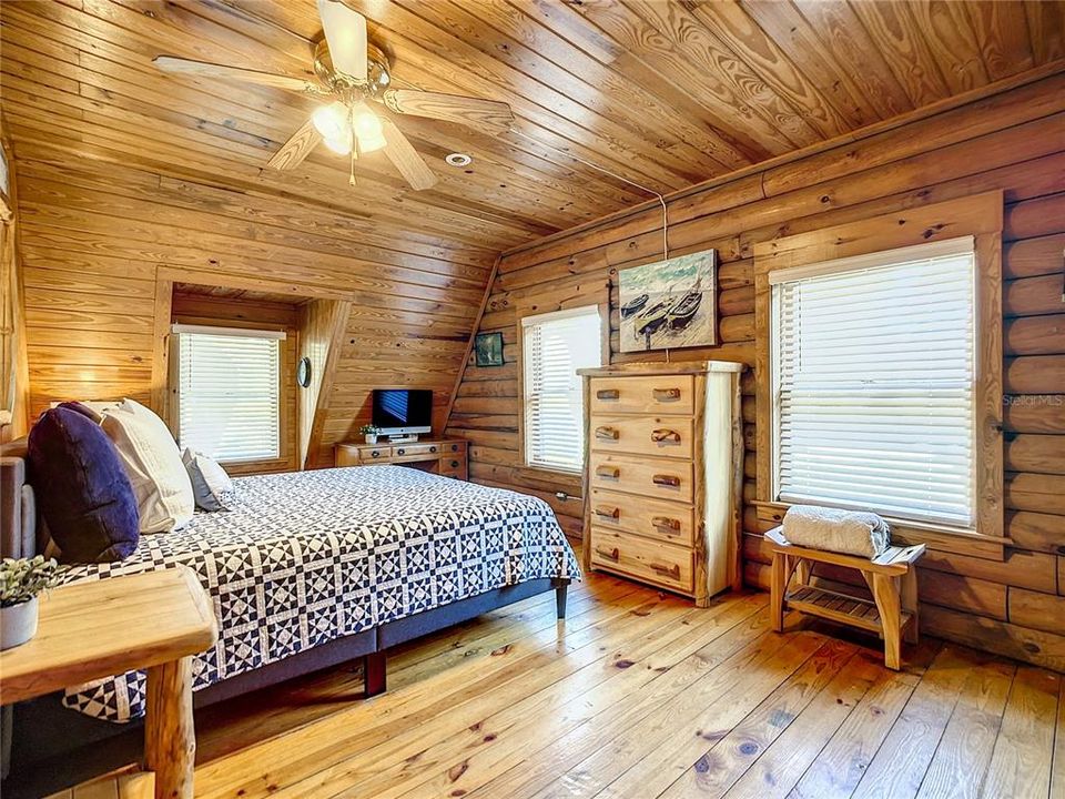 Feel wrapped in warmth in the serenity that fills this cozy home! The bedrooms are plenty sizeable and come furnished with this king sized bed, two end tables, an oversized wood framed mirror, and two custom wood dressers.