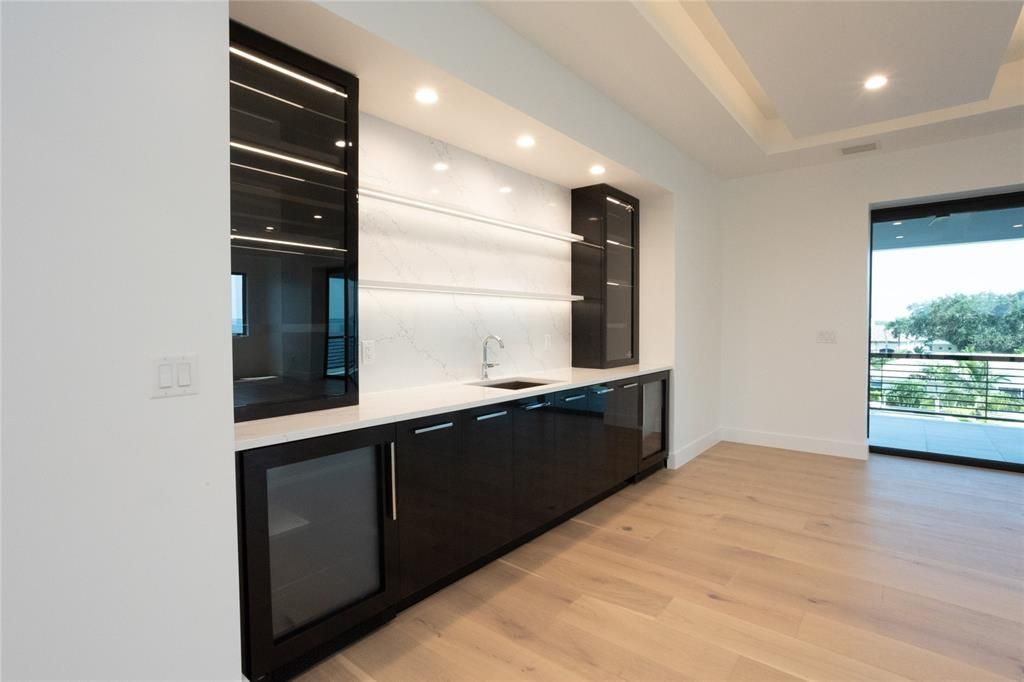 Multi Purpose room with Wet bar, wine fridge, and Mini fridge