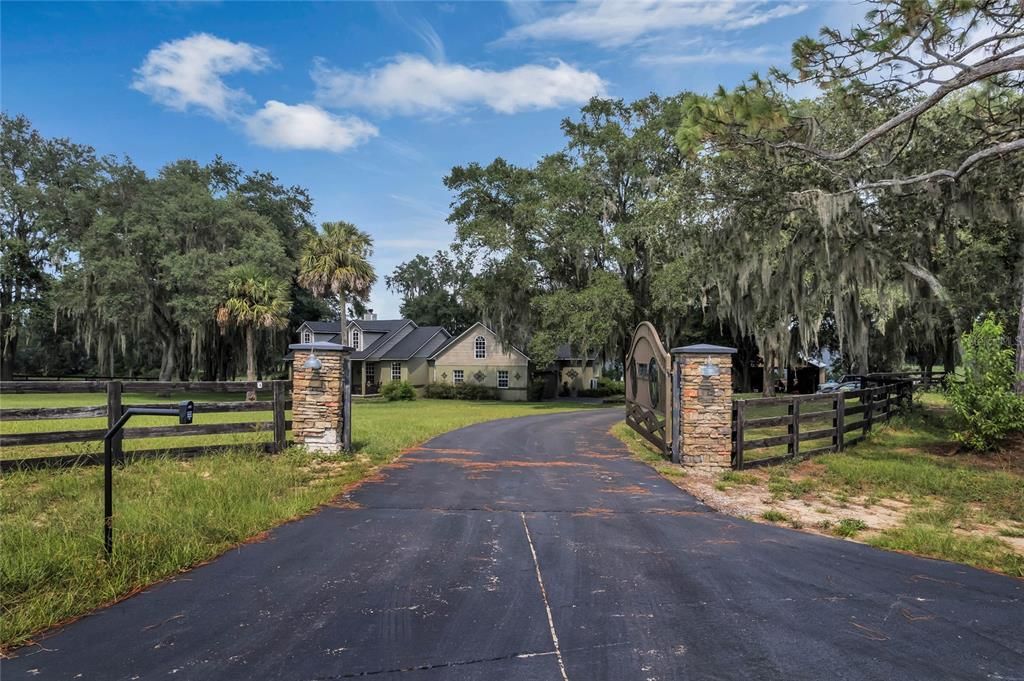 Custom electric gate, long driveway and totally fenced 2.6-acre paradise.