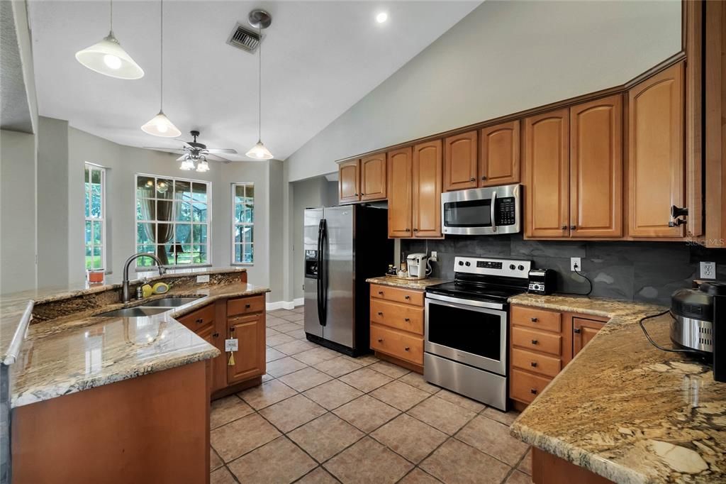 Maple cabinets, granite countertops, stainless steel appliances and new slate backsplash.