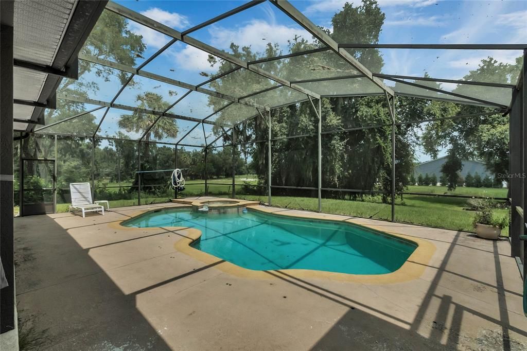 The screened-in pool is perfect for cooling off on hot summer days.