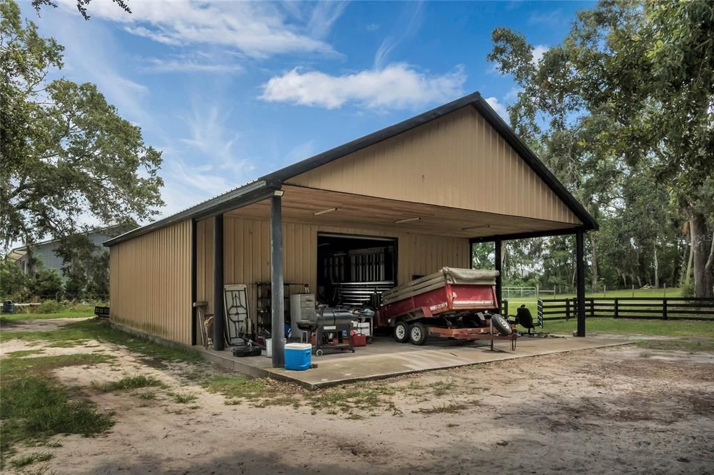 LARGE 40' x 60' Shop (currently used as a welding shop). Covered front includes tongue & groove ceiling. There is also a 1/2 bath inside the shop.