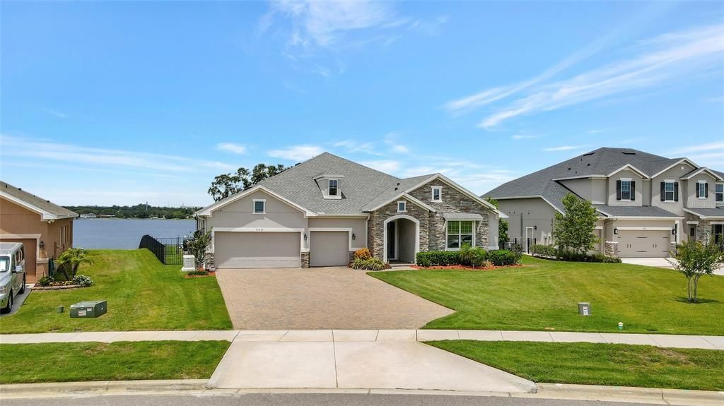 This home sits on over 1.4 acres of land, offers stunning panoramic views of Johns Lake, custom designed pool & spa with swim-up pool bar, waterfall and luxury custom designed kitchen with concrete wall.