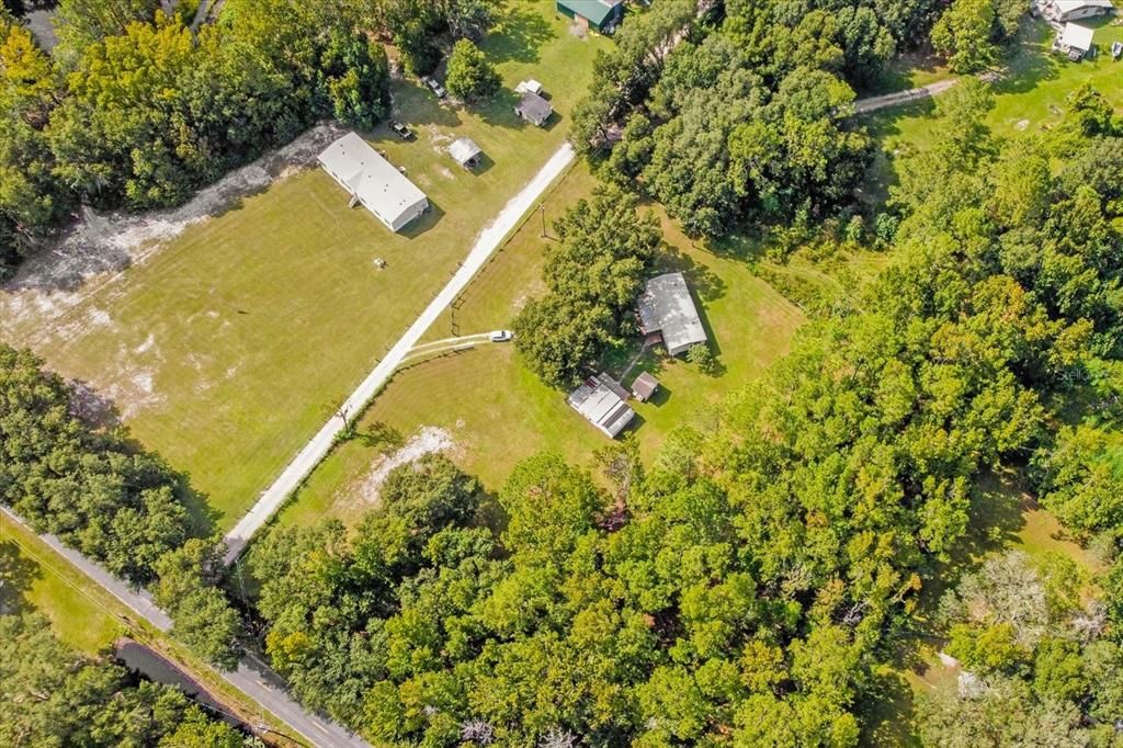 The 5 acres include all the land from the road, the land behind the home all the way back to the neighbors. The driveway is owned by the Seller and maintained by all the neighbors.