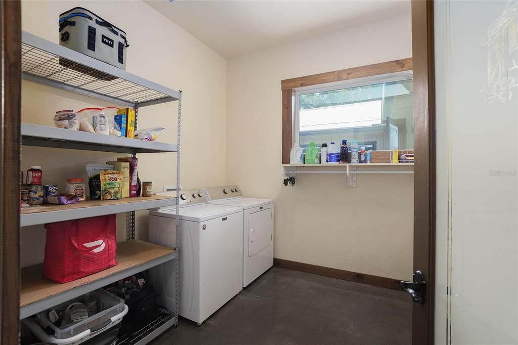 Laundry room off kitchen area with pantry.