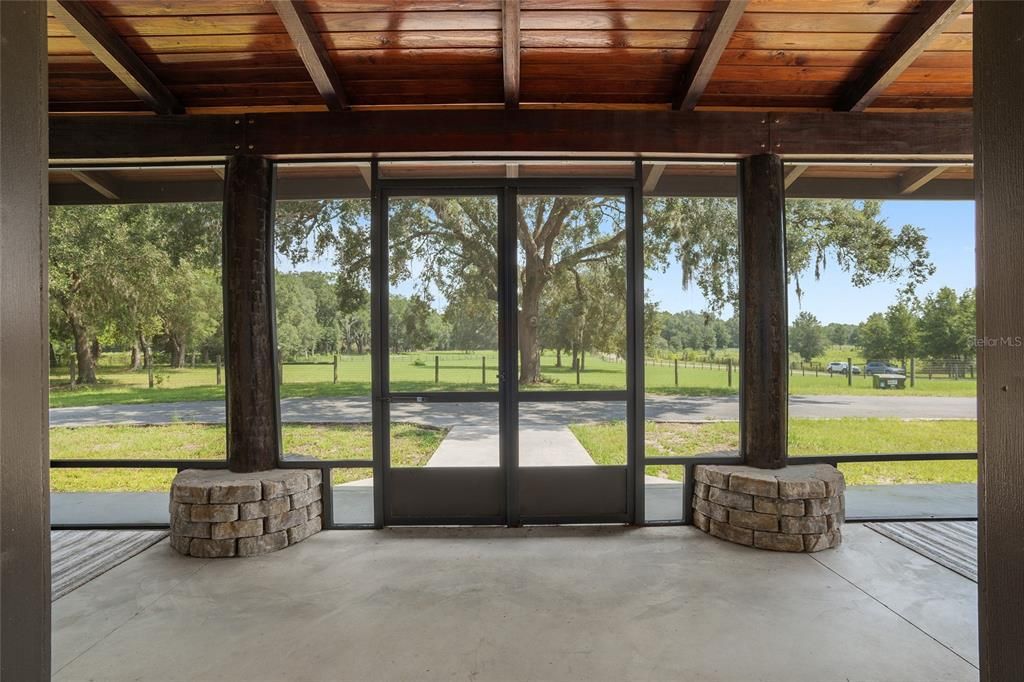 Screened-in front porch with serene view