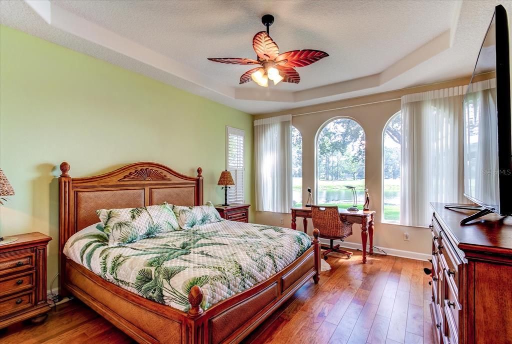 Master Bedroom Features Arched, Tray Ceilings, Wood Floors