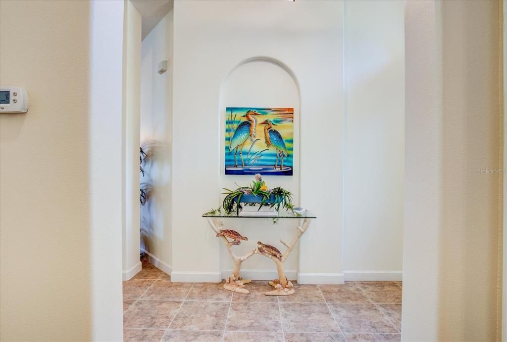 The Foyer at the Entrance of the Home Has Space for Artwork as Well As Furniture