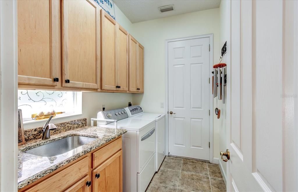 The Laundry Features Built in Cabinetry as Well as a Laundry Sink. Granite Counters. Convenient for a Drop Off Place for Groceries, ets.