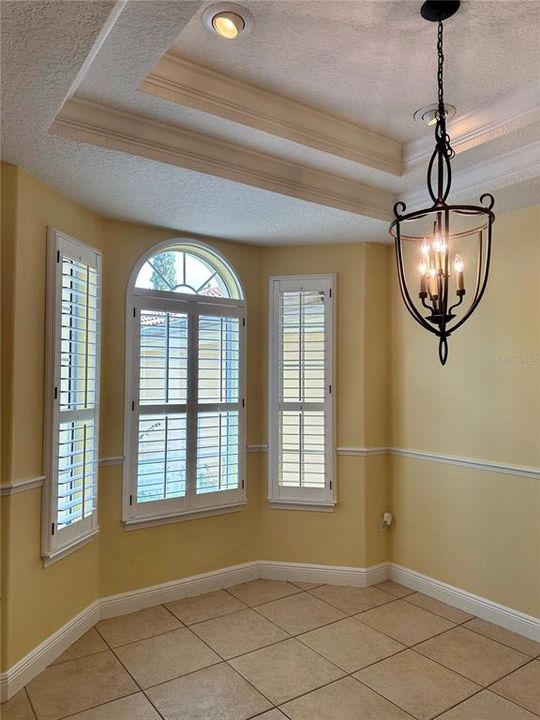 Formal dining room with trayed ceiling