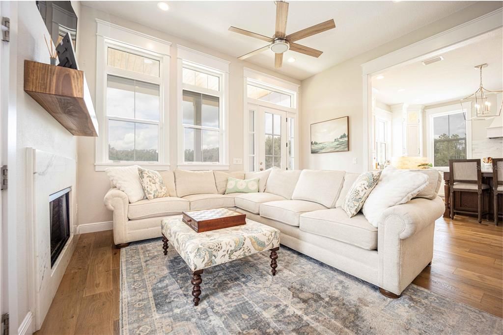 Living area fixated with high ceilings & an open floor plan to the kitchen