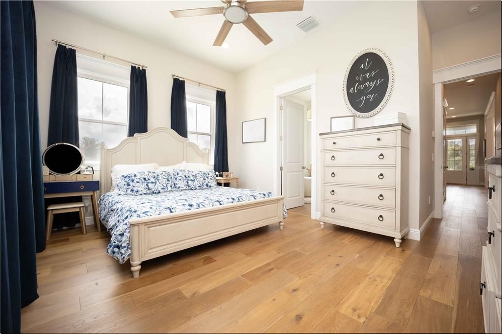 Master Bedroom with wood floors and high ceiling