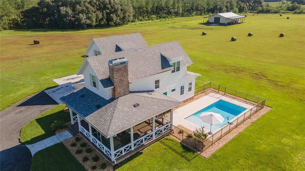 Side view of home with view of enclosed patio and in ground pool!