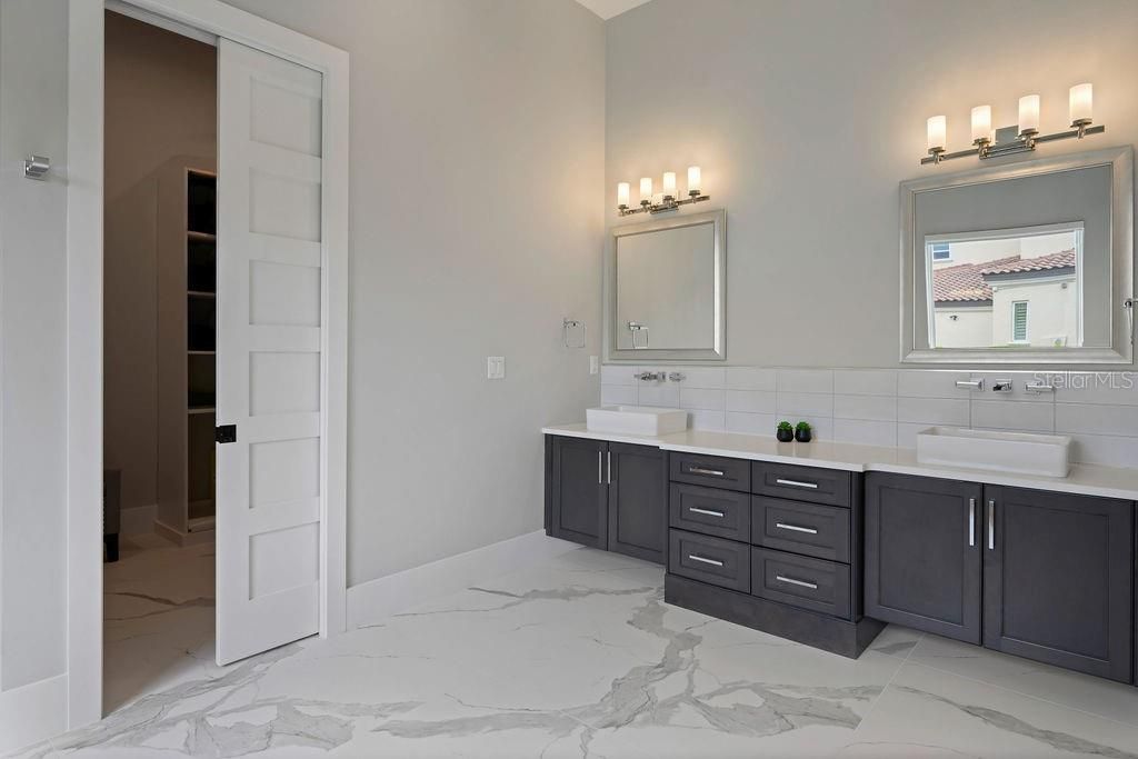 First floor master bathroom with double sinks and expanded vanity are benefits as well as double drawer sets and vessel sinks complimented with waterfall faucets make it very special.