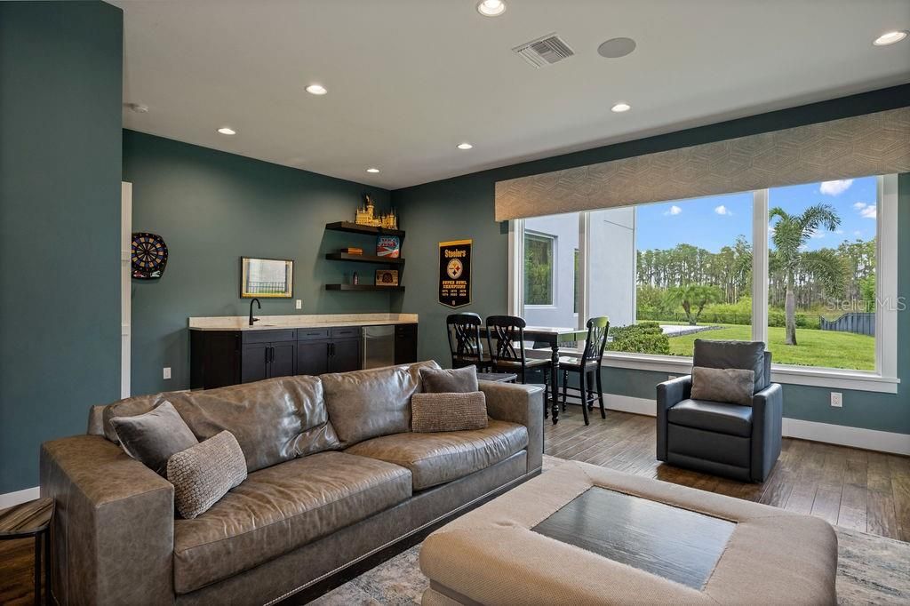 The media room has a lovely view of the oversized property via the expansive windows and is so welcoming with all of the natural lighting. Movie night, play room, exercise room there are so many options to utilize this space for your personal families function.