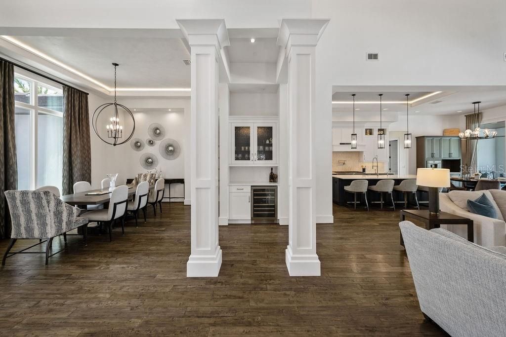 Note the entertaining ease of the floor plan as you can easily entertain in the dining area with access to the wine closet and beverage bar which includes a Zephyr dual zone wine chiller and cabinet storage for your favorite wine glasses.