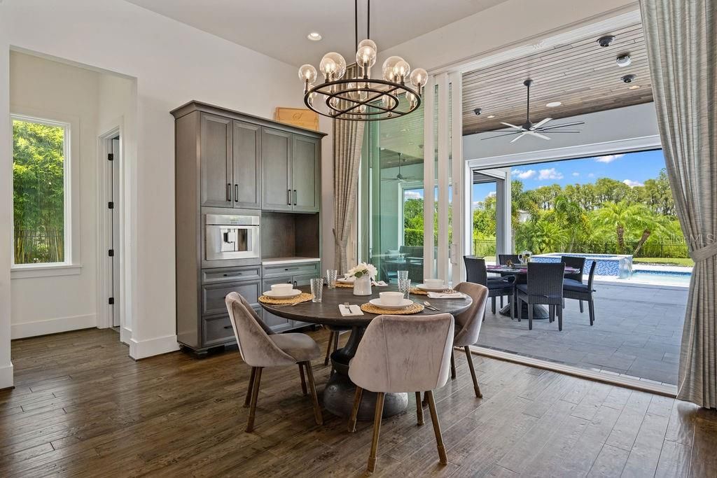 Dedicated breakfast nook is complemented with beverage bar that includes a Thermador built in Coffee Machine with Barista style quality.