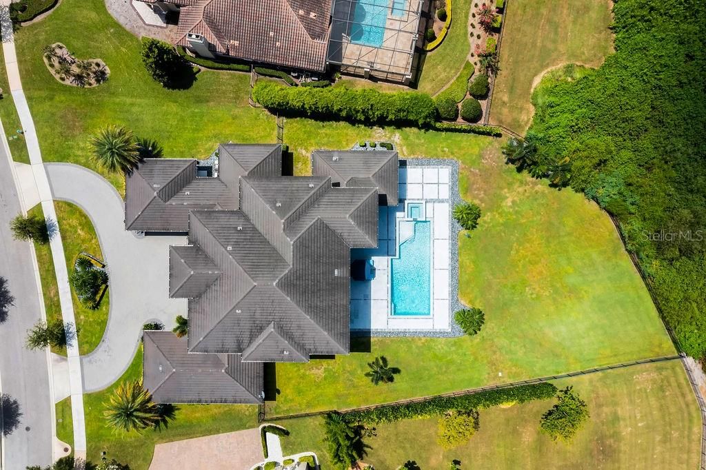 Although the pool is oversized this lot which is over an acre still allows for plenty of run around space in the rear.